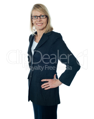 Senior female manager poisng with hands on her waist