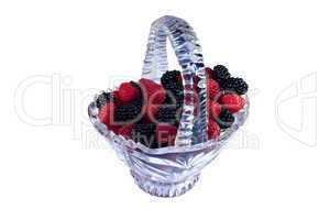 Glass basket full of raspberries and blackberries
