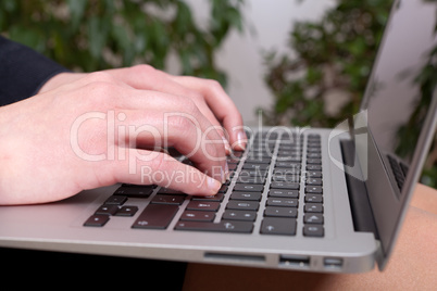 Junge Geschäftsfrau mit einem Notebook auf ihren Knien am arbeiteten