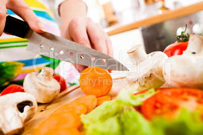 Woman's hands cutting vegetables