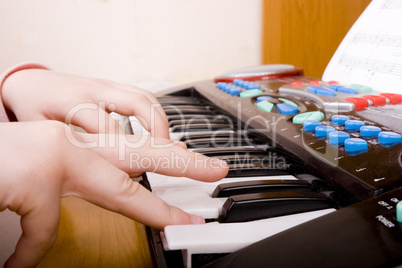 child playing at piano