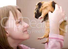 little girl holding guinea pig