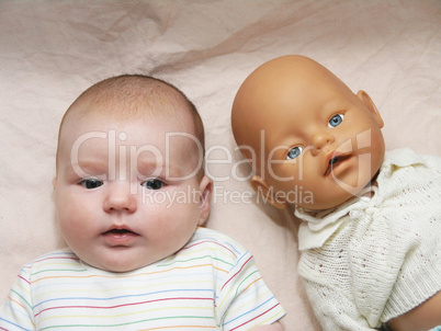 newborn baby and doll