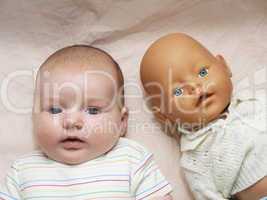 newborn baby and doll