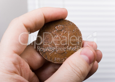 old coin in hand
