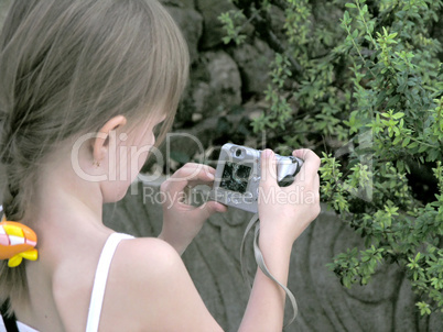 child shooting with small camera