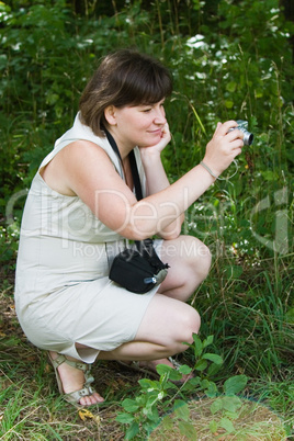 woman shooting with small camera