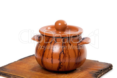 Dirty ceramic pot on old kitchen board