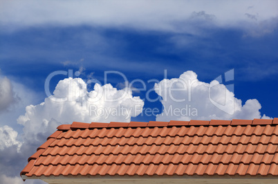 Roof tiles and blue sky with clouds