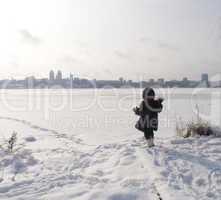 girl at thebank of frozen river