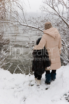 mother and daughter look at the river