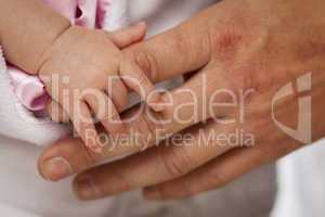 Baby Girl Hand Holding Rough Finger of Dad
