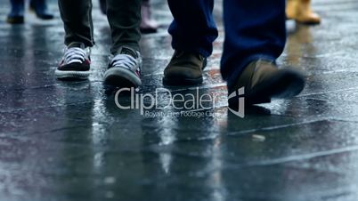 Many People Walking on a Rainy Day with wet shoes in the City with Rain Reflection, in Full HD 1080p
