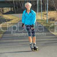 Woman roller skating in park smiling summer