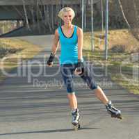 Woman roller skating in park smiling summer