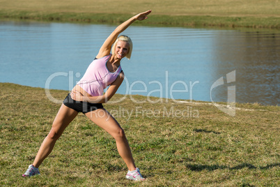 Young woman stretching outdoors before jogging