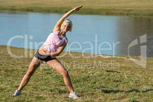 Young woman stretching outdoors before jogging