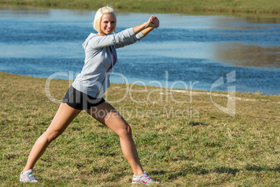 Young woman stretching outdoors before jogging