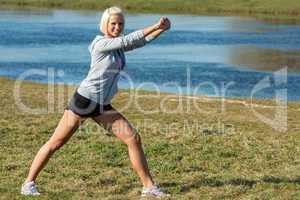 Young woman stretching outdoors before jogging