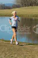 Running woman outdoor sport by river bank
