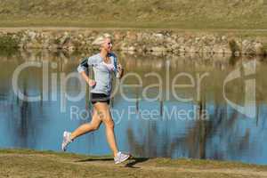 Running woman outdoor sport by river bank