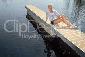 Young sport woman relax on pier lake