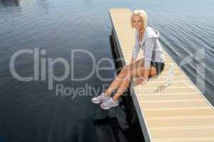 Young sport woman relax on pier water