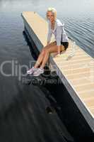 Young sport woman relax on pier lake