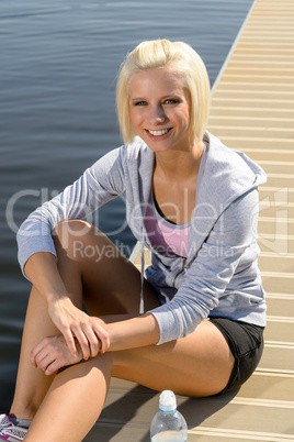 Young sport woman relax on pier water