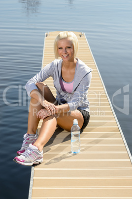 Young sport woman relax on pier lake