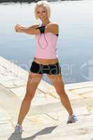 Fit woman stretch body by pier marina