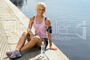 Sport woman smiling relax water sitting pier