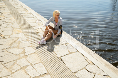 Sport woman relax on pier looking water