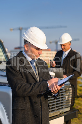 Architect man make notes on construction site