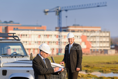 Architect man make notes on construction site