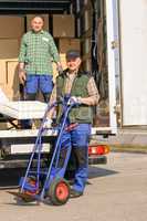 Mover two man loading furniture on truck