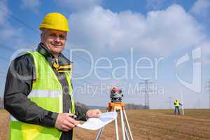 Geodesist wear reflective vest measure land