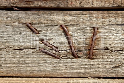 Rusty nails in wooden shield