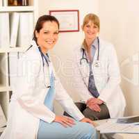 Two female doctor sitting surgery office