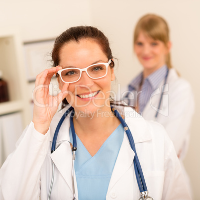 Doctor woman white glasses looking at camera