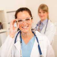 Doctor woman white glasses looking at camera