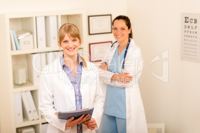 Two female doctor standing at medical office