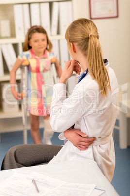 At the pediatrician little girl with crutches