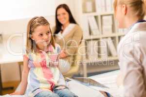 At pediatrician office girl looking at doctor