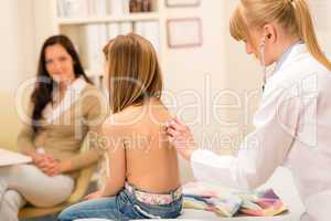Pediatrician check child back with stethoscope.