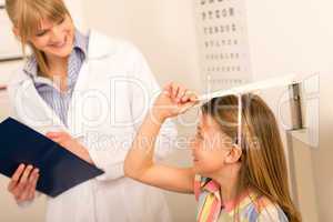 Pediatrician measure height of little girl