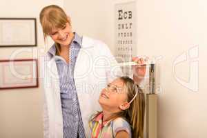 Pediatrician measure height of little girl