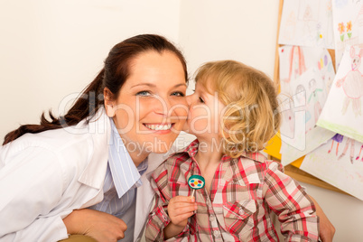 Pediatrician woman get kiss from child girl