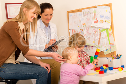 Pediatrician female observe children play activity