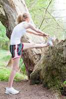 young woman is jogging in forest